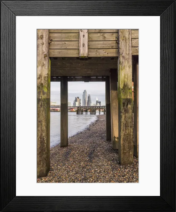 Framed Print : City of London skyline through a wooden bridge on the River Thames, London, England Framed Print : City of London skyline through a wooden bridge on the River Thames, London, England