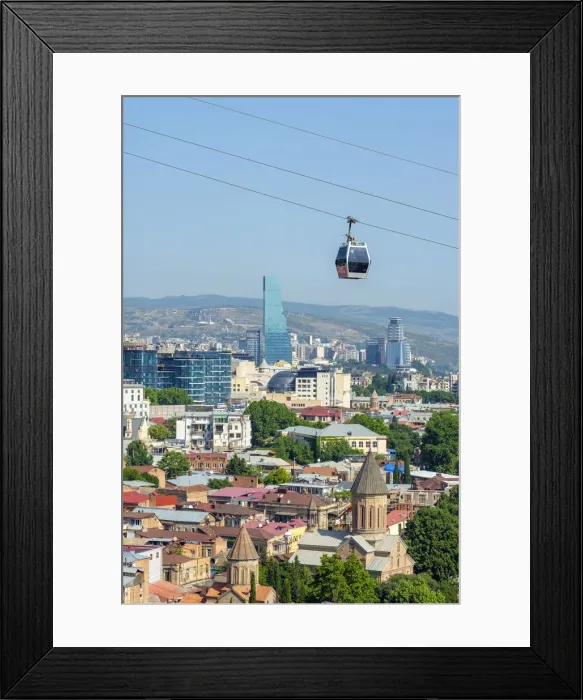 Framed Print : Cable car between Rike Park and the Narikala fortress passes above buildings in central Framed Print : Cable car between Rike Park and the Narikala fortress passes above buildings in central