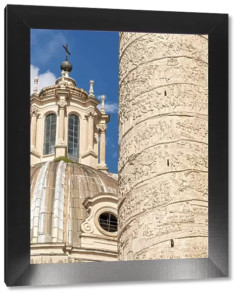 Europe, Italy, Rome. Close up of the Trajans column with the cupola of the church