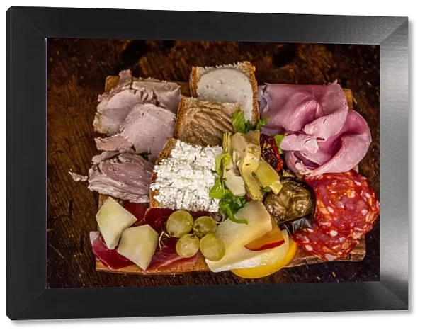 Europe, Italy, Rome. A platter with typical italian starters, cheese and cold meats
