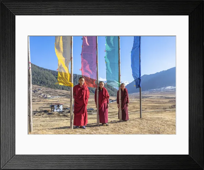 Framed Print : Novice Monks (Child Monks) standing in front of prayer flags in Phobjikha Valley, Bhutan