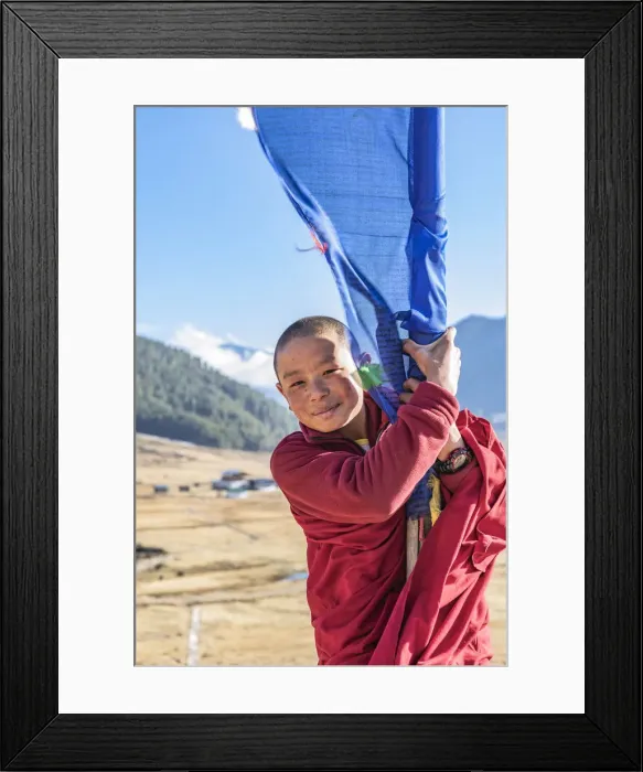 Framed Print : Novice Monks(Child Monk) standing next to a prayer flag in Phobjikha Valley, Bhutan Framed Print : Novice Monks(Child Monk) standing next to a prayer flag in Phobjikha Valley, Bhutan