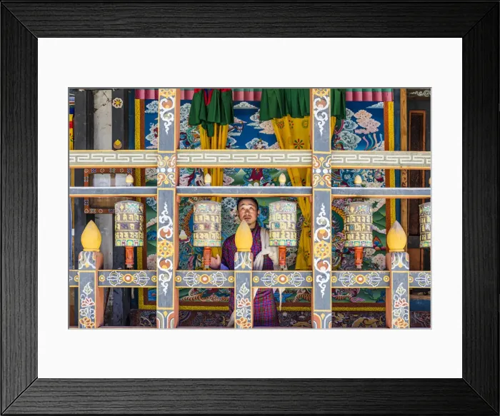 Framed Print : A man spinning prayer wheels in Trongsa Dzong, Trongsa District, Bhutan