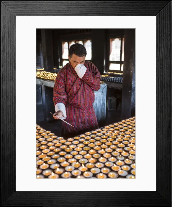 Framed Print : A man lighting candles in a shrine in Jambey Lhakhang, Jakar, Bumthang District, Bhutan Framed Print : A man lighting candles in a shrine in Jambey Lhakhang, Jakar, Bumthang District, Bhutan
