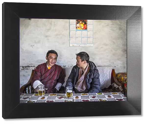Two Bhutanese men drinking beer in a local bar, Ura, Bumthang District, Bhutan