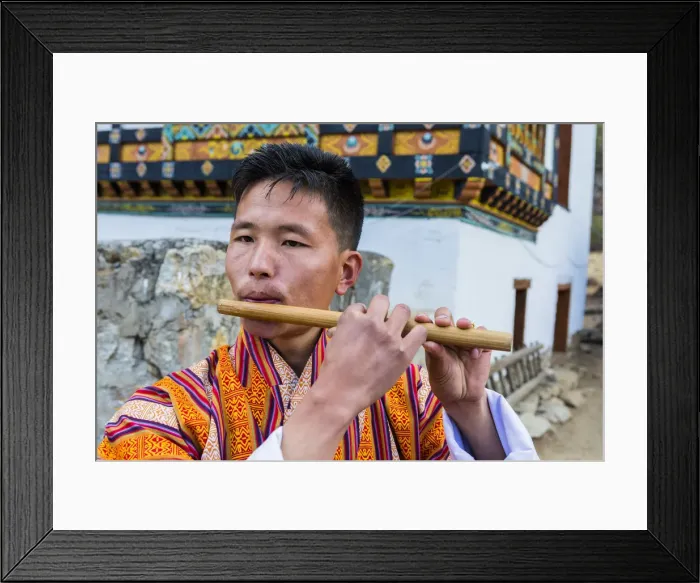 Framed Print : A man playing the flute at a local festival in Paro District, Bhutan Framed Print : A man playing the flute at a local festival in Paro District, Bhutan