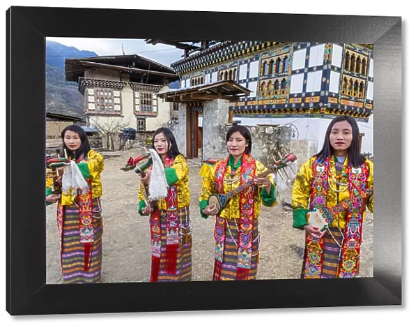 Female performers playing instruments at a local festival in Paro District, Bhutan