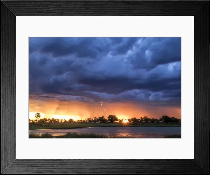 Framed Print : Lightning shoots from a summer thunderstorm as the sun sets behind it, Okavango Delta Framed Print : Lightning shoots from a summer thunderstorm as the sun sets behind it, Okavango Delta