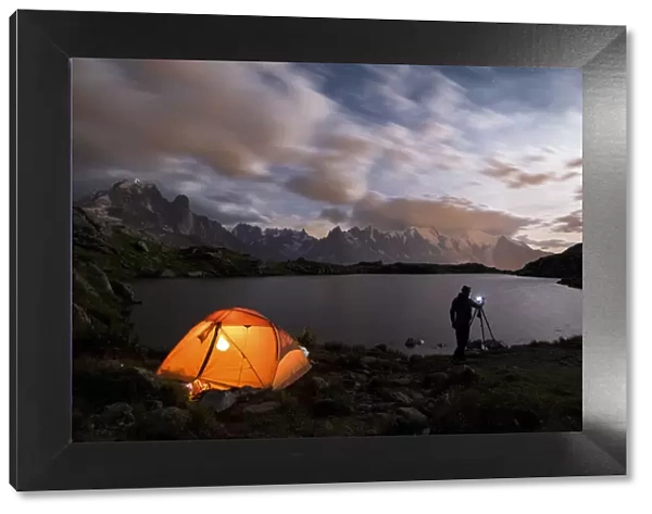 Tent and photographer in front of Mont Blanc from Lac de Chesery during summer night