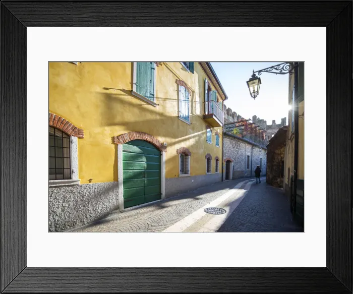 Framed Print : Lazise sul Garda, Verona province, Veneto, Italy A woman walking in the old town centre Framed Print : Lazise sul Garda, Verona province, Veneto, Italy A woman walking in the old town centre