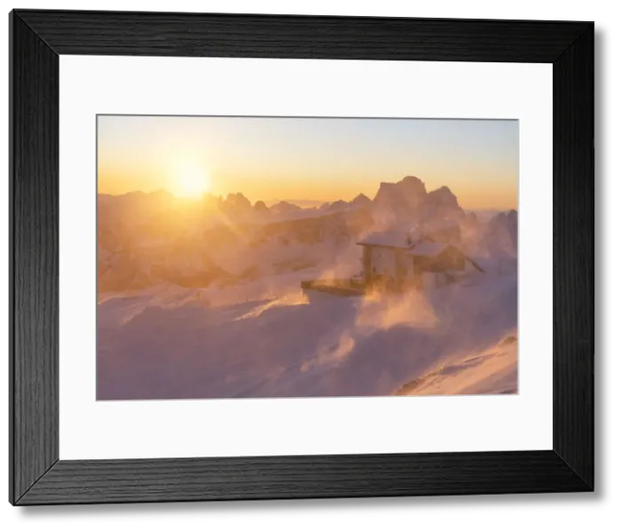 Framed Print : a windstorm lifts the snow in a cold winter sunrise at the Lagazuoi refuge Framed Print : a windstorm lifts the snow in a cold winter sunrise at the Lagazuoi refuge