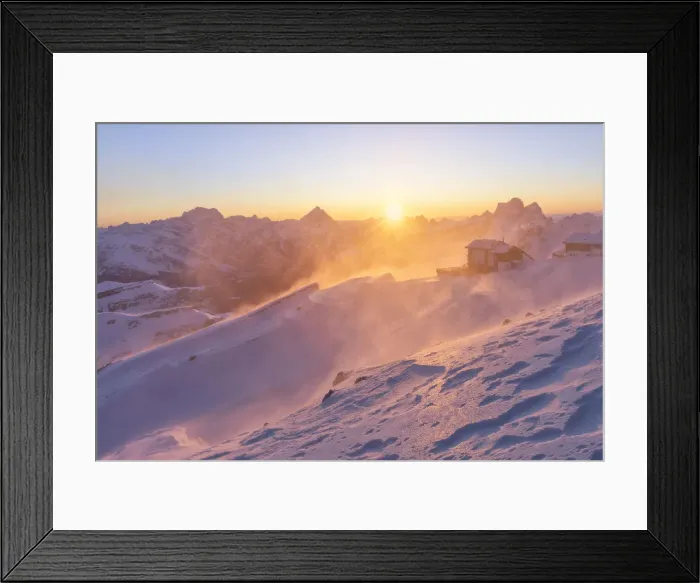 Framed Print : a windstorm lifts the snow in a cold winter sunrise at the Lagazuoi refuge