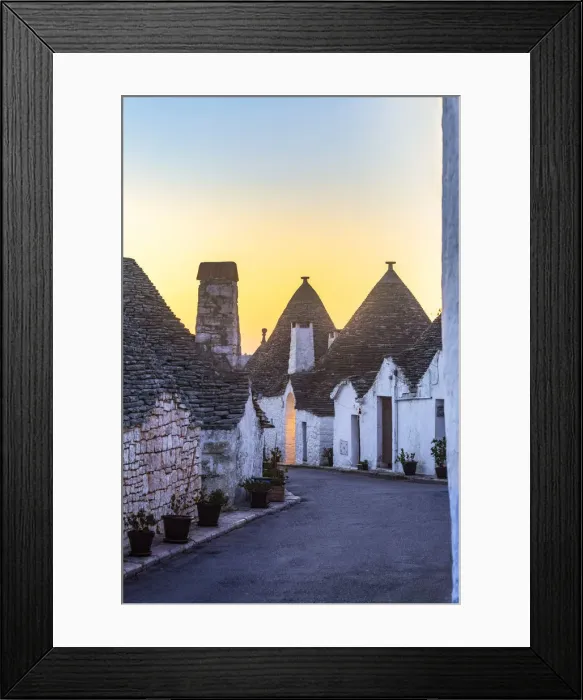 Framed Print : The sunrise illuminates sky above monumental trulli area