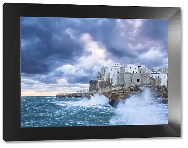 Waves crash on the cliff during a winter storm. Polignano a Mare, Apulia, Italy