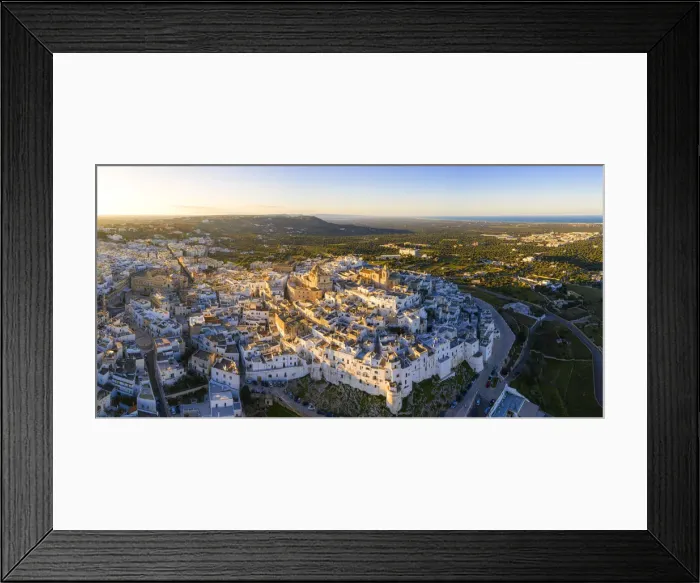 Framed Print : Aerial view of the old town of Ostuni at sunset, Apulia, Italy Framed Print : Aerial view of the old town of Ostuni at sunset, Apulia, Italy