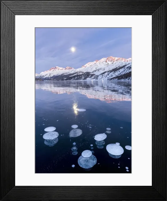 Framed Print : Methane bubbles in the icy surface of Silsersee with snowy peak illuminated by sunset Framed Print : Methane bubbles in the icy surface of Silsersee with snowy peak illuminated by sunset
