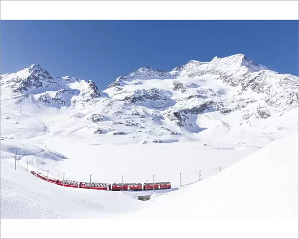 Bernina Express transit along Lago Bianco in winter, Bernina Pass, Engadin