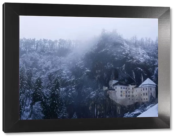 Predjama castle during a snowy day in the middle of the wintern, Predjama, Slovenia