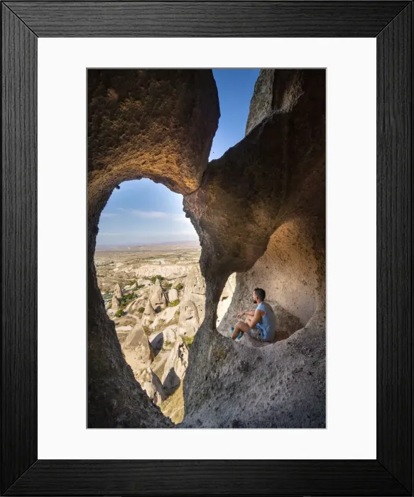 Framed Print : Tourist admiring Capadocias landscape from a tuff cave Framed Print : Tourist admiring Capadocias landscape from a tuff cave