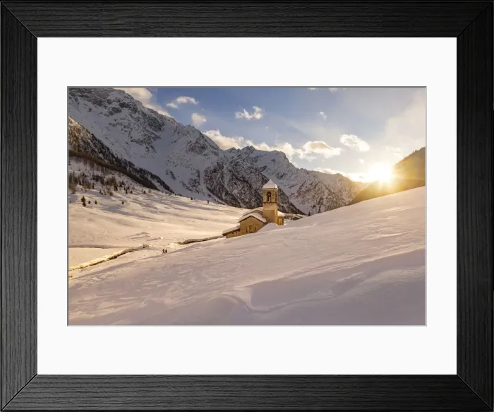 Framed Print : Alpine church of San Bernardo at sunset light in a mountain valley during winter season Framed Print : Alpine church of San Bernardo at sunset light in a mountain valley during winter season