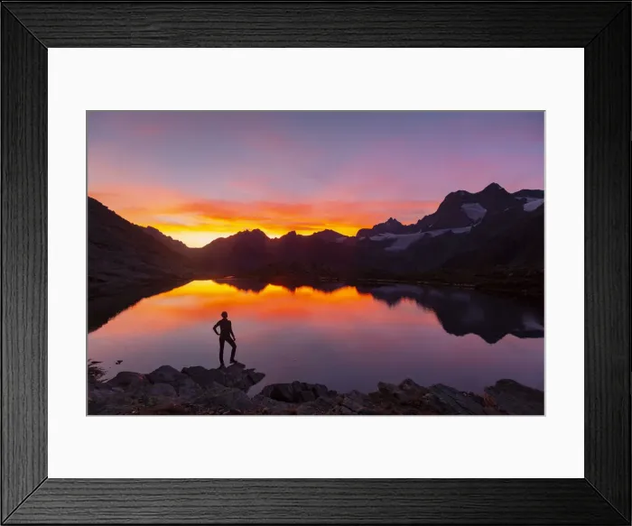 Framed Print : Sunsetscape of an hiker at Confinale pass lake during a summer sunset Framed Print : Sunsetscape of an hiker at Confinale pass lake during a summer sunset