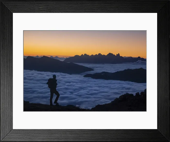 Framed Print : Hiker admiring sunrise in Dolomites mountains with Pale di San Martino group in