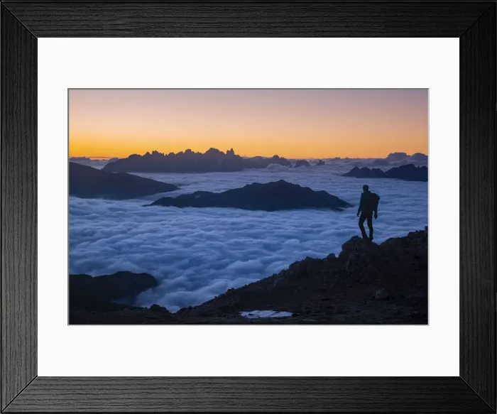 Framed Print : Hiker admiring sunrise from Latemar with Pale di San Martino group in background over a Framed Print : Hiker admiring sunrise from Latemar with Pale di San Martino group in background over a