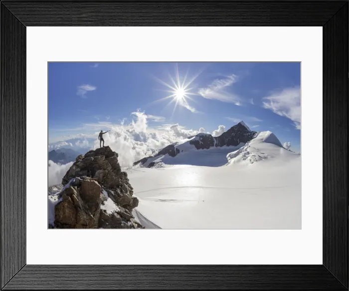 Framed Print : Alpinist over a rock near Balmenhorn bivac looking to Lyskamm peak with sun in backlight Framed Print : Alpinist over a rock near Balmenhorn bivac looking to Lyskamm peak with sun in backlight