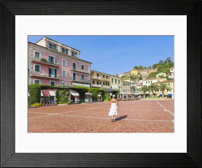 Framed Print : A Girl is walking in the square of Porto Azzurro (Elba Island, Livorno, Tuscany