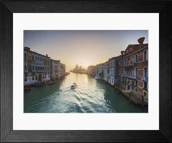 Framed Print : A small boat sails along Canal Grande view from the Academy bridge, Venice, Veneto, Italy Framed Print : A small boat sails along Canal Grande view from the Academy bridge, Venice, Veneto, Italy
