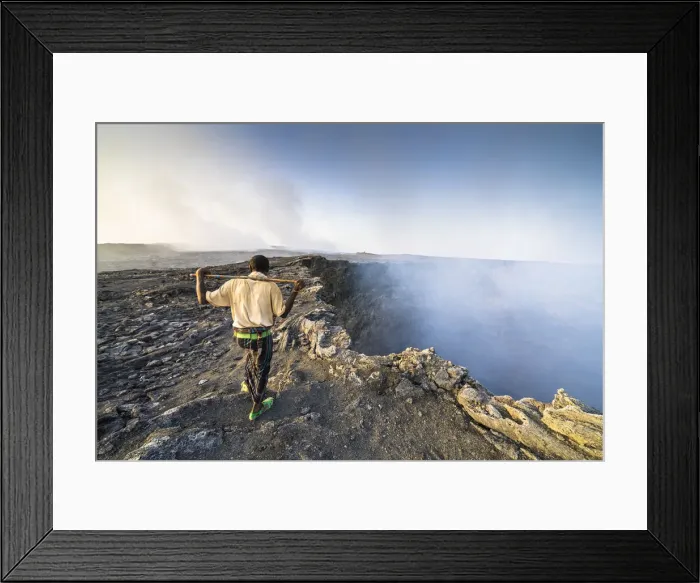 Framed Print : Afar man looking at the smoke coming out from Erta Ale volcano caldera Framed Print : Afar man looking at the smoke coming out from Erta Ale volcano caldera