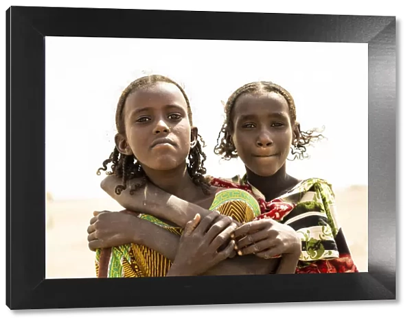 Portrait of young sisters girls with braids, Asaita, Afar Region, Ethiopia, Africa