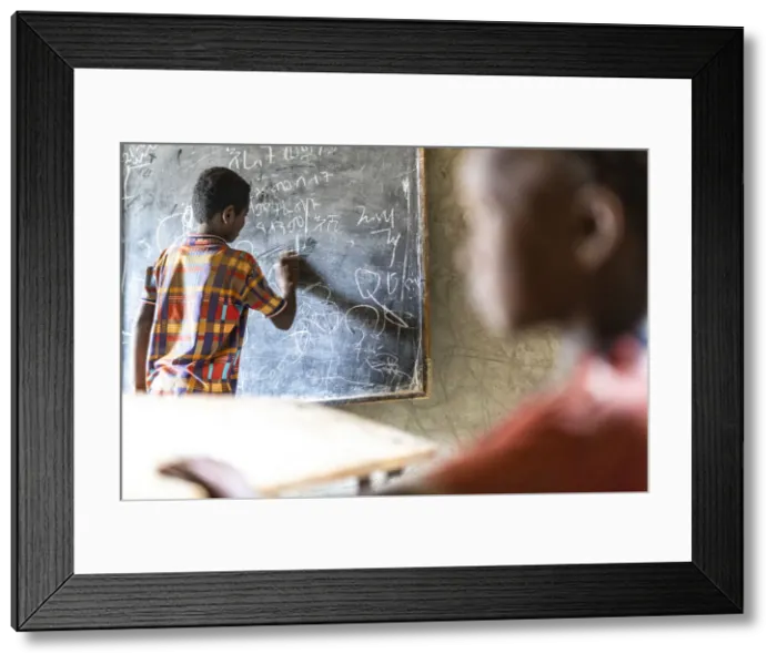 Framed Print : Young boy writing on blackboard at school, Melabday, Asso Bhole, Danakil Depression