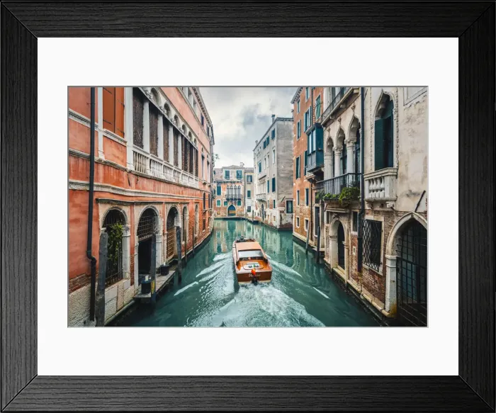 Framed Print : A boat cruising a green canal in Venice, Veneto, Italy Framed Print : A boat cruising a green canal in Venice, Veneto, Italy