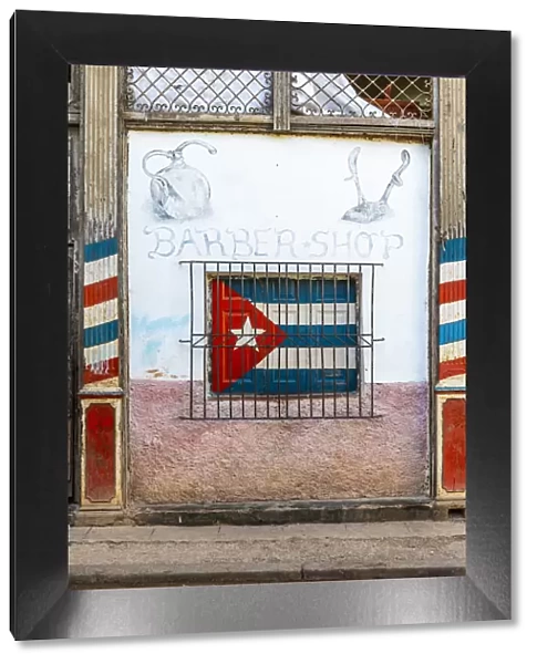 Cuban flag painted on the window of a barber shop in La Habana Vieja (Old Town), Havana