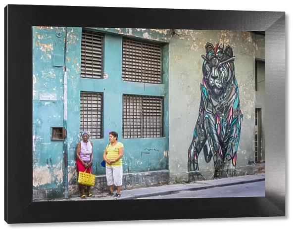 Two women talking in a street in La Habana Vieja (Old Town), Havana, Cuba