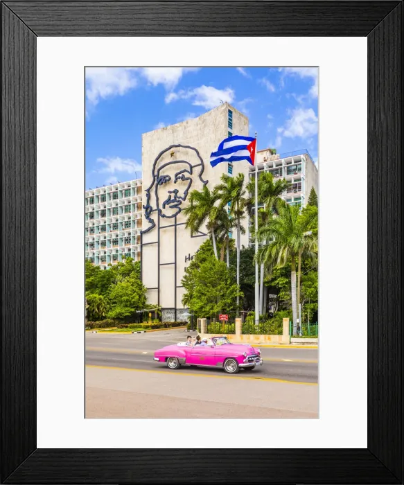 Framed Print : A classic car driving in front of a building with an outline of Che Guevara Framed Print : A classic car driving in front of a building with an outline of Che Guevara