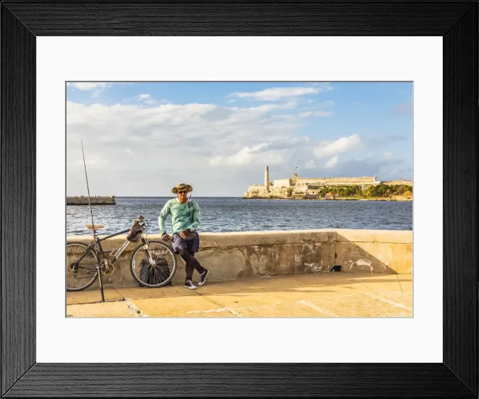 Framed Print : A man with fishing equipment on the Malacon with Castillo De Los Tres Reyes Del Morro Framed Print : A man with fishing equipment on the Malacon with Castillo De Los Tres Reyes Del Morro