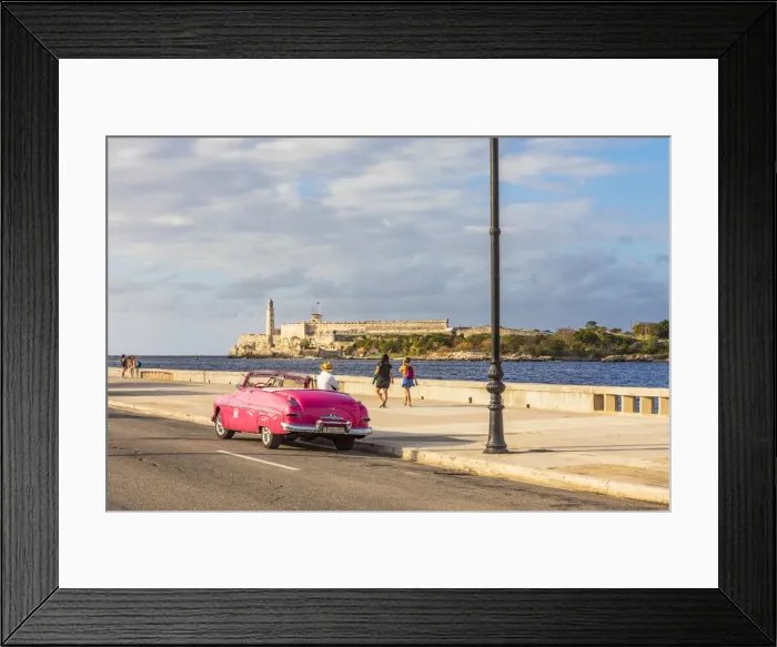 Framed Print : Classic car driving along the Malecon with Castillo De Los Tres Reyes Del Morro Framed Print : Classic car driving along the Malecon with Castillo De Los Tres Reyes Del Morro