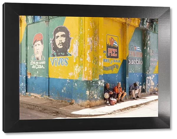 People sitting on a street corner in La Habana Vieja (Old Town), Havana, Cuba