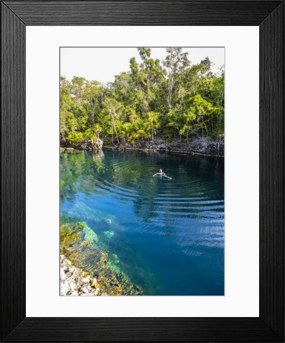 Framed Print : A man swimming in a natural water swiming pool in Playa Giron, Bay of Pigs
