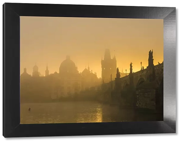 Charles Bridge with mist at sunrise, Prague, Bohemia, Czech Republic