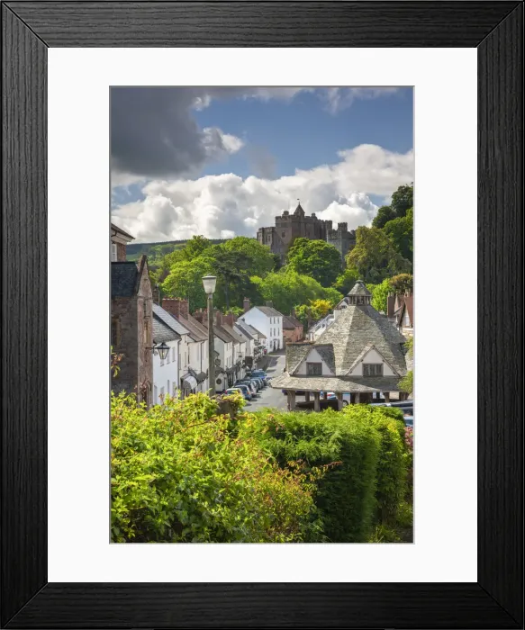 Framed Print : Dunster High Street, with the Yarn Market on the right and Dunster Castle beyond Framed Print : Dunster High Street, with the Yarn Market on the right and Dunster Castle beyond