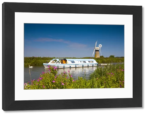 Cruiser on River Thurne with St. Benets Mill, Norfolk Broads National Park