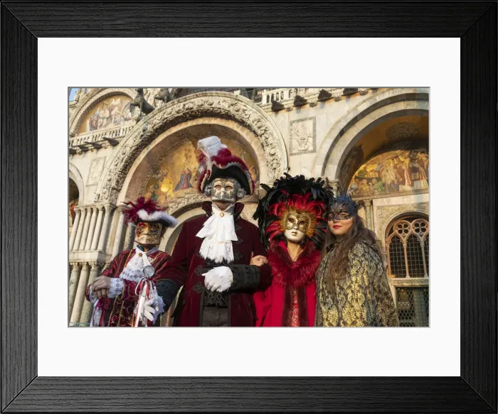 Framed Print : Four people dressed up during the Venice Carnival stand in front of the Basilica in St Framed Print : Four people dressed up during the Venice Carnival stand in front of the Basilica in St