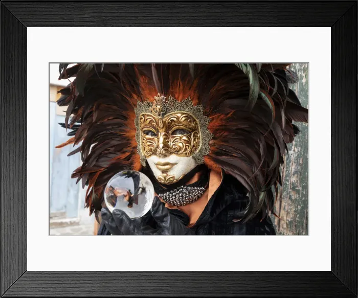 Framed Print : A woman in a feather Venetian mask poses with a glass ball during the Venice Carnival Framed Print : A woman in a feather Venetian mask poses with a glass ball during the Venice Carnival