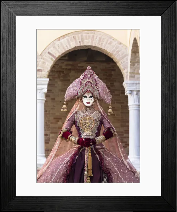 Framed Print : A woman wearing an Indian style costume and mask poses in the cloisters of Chiesa di San Framed Print : A woman wearing an Indian style costume and mask poses in the cloisters of Chiesa di San