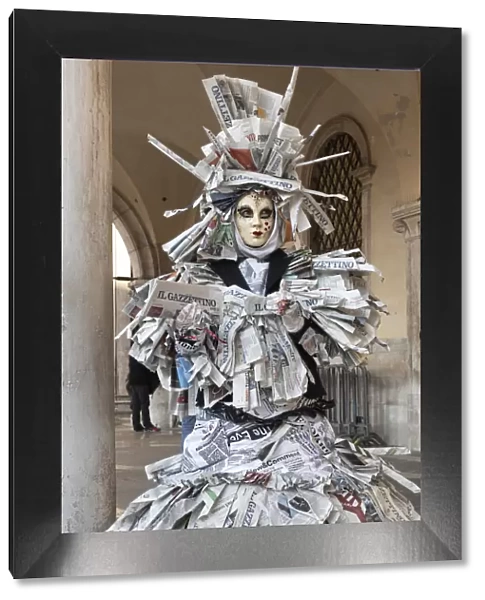 A woman covered in newspaper walks through St. Mark