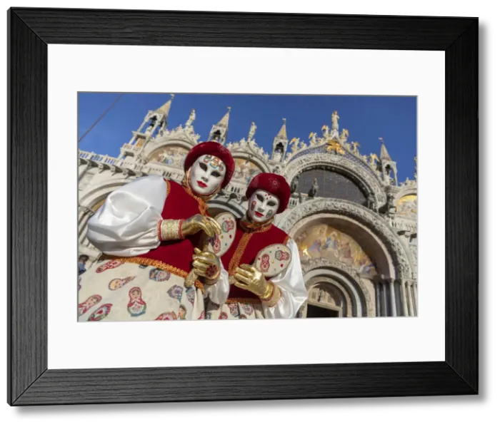 Framed Print : Two girls dressed as Russian dolls stand in front of the Basilica in St Framed Print : Two girls dressed as Russian dolls stand in front of the Basilica in St