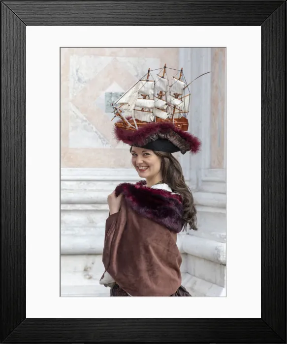 Framed Print : A woman wearing a hat decorated with an old sailing ship poses at the Venice Carnival Framed Print : A woman wearing a hat decorated with an old sailing ship poses at the Venice Carnival